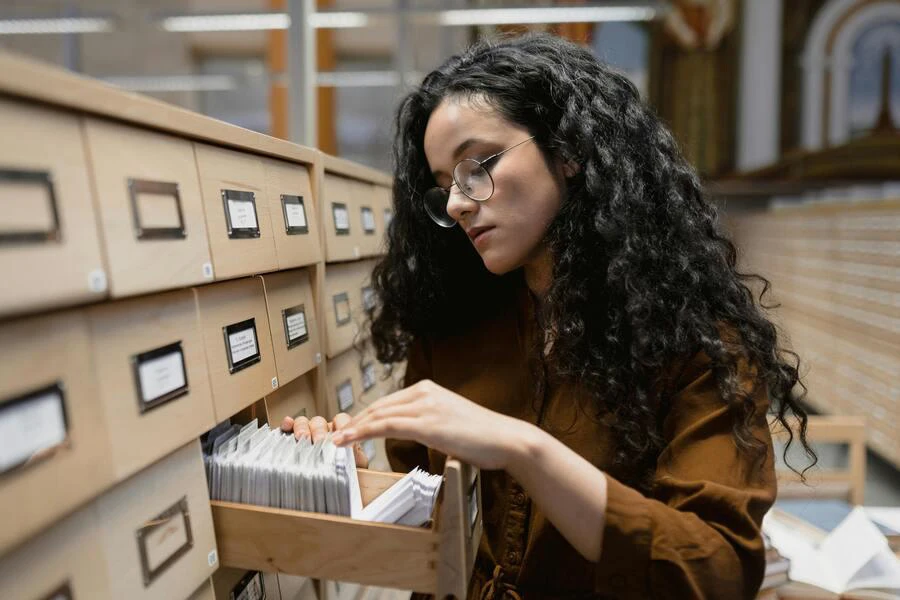 Woman with black curly hair browsing through records