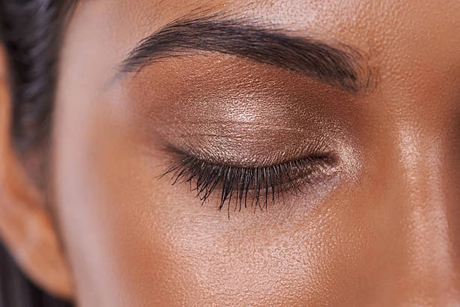 Woman with dark skin tone wearing dark brown eyeshadow