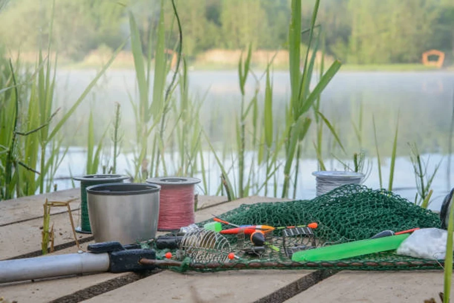 Wooden dock with blockend feeders and fishing items on top