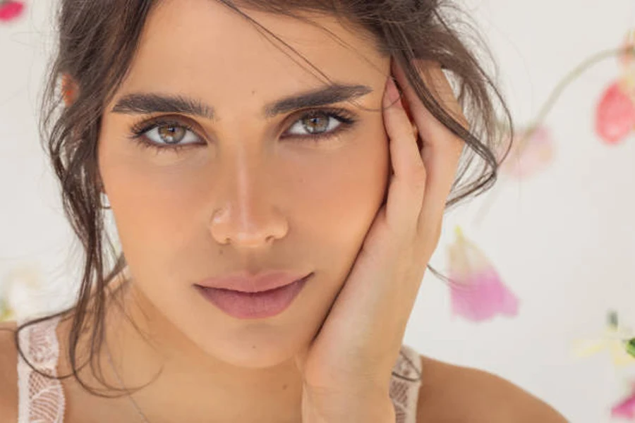 Young woman with brown hair wearing contrast makeup look