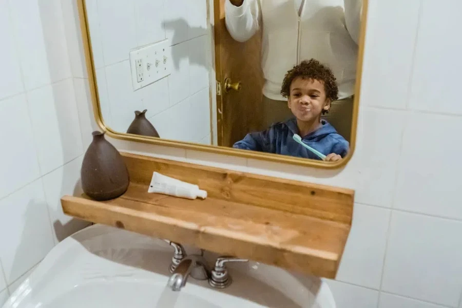 A child brushing while looking at the wooden bathroom and mirror combo