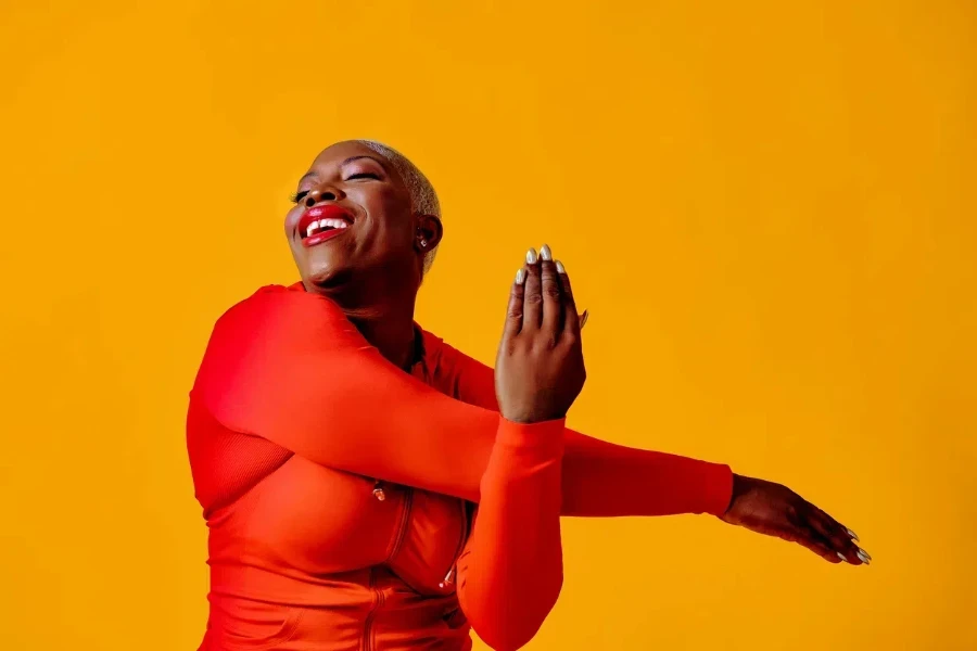 A curvy woman in a red sleep jumpsuit