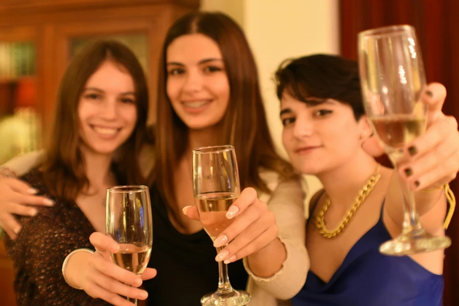 a group of women holding up wine glasses