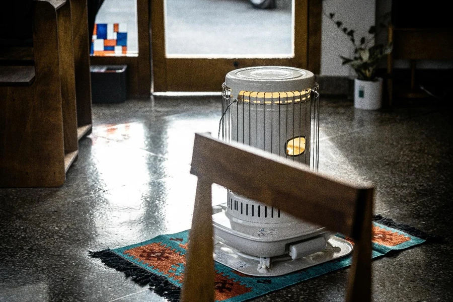 a metal cage heater on a rug