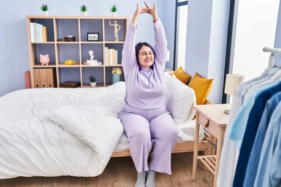 A plus-size woman in purple pajamas