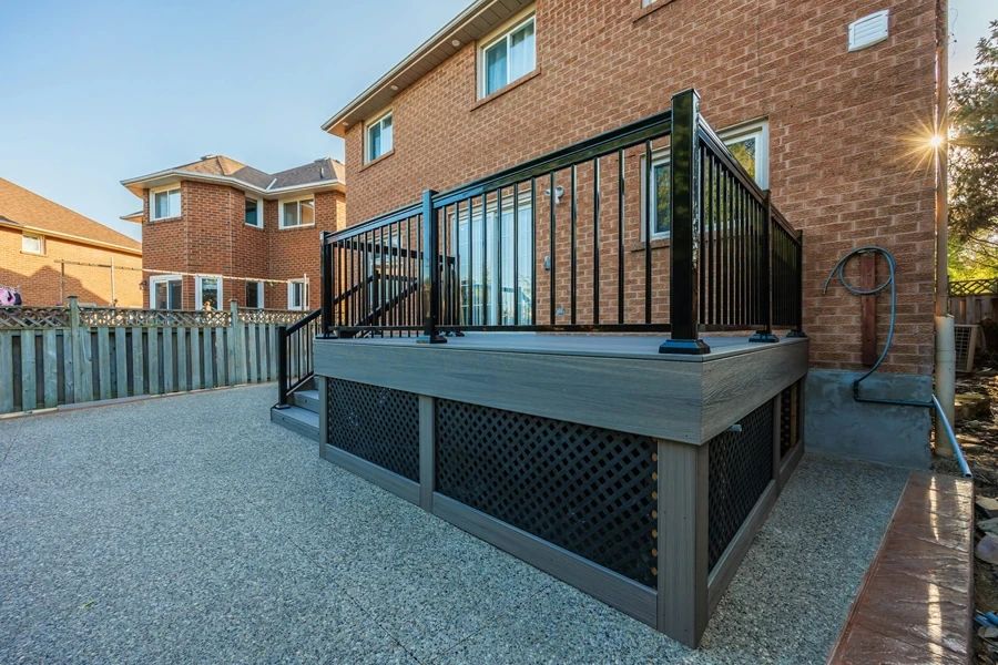 a small wood deck with metal railing