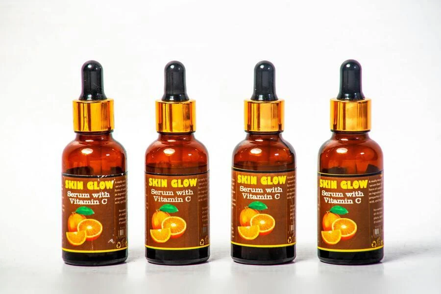 bottles with vitamin C serum made with orange extracts