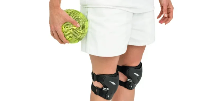 woman wearing and adjusting her safety knee protectors pads