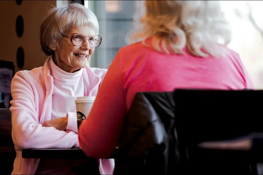 Photo of two senior women having a conversation