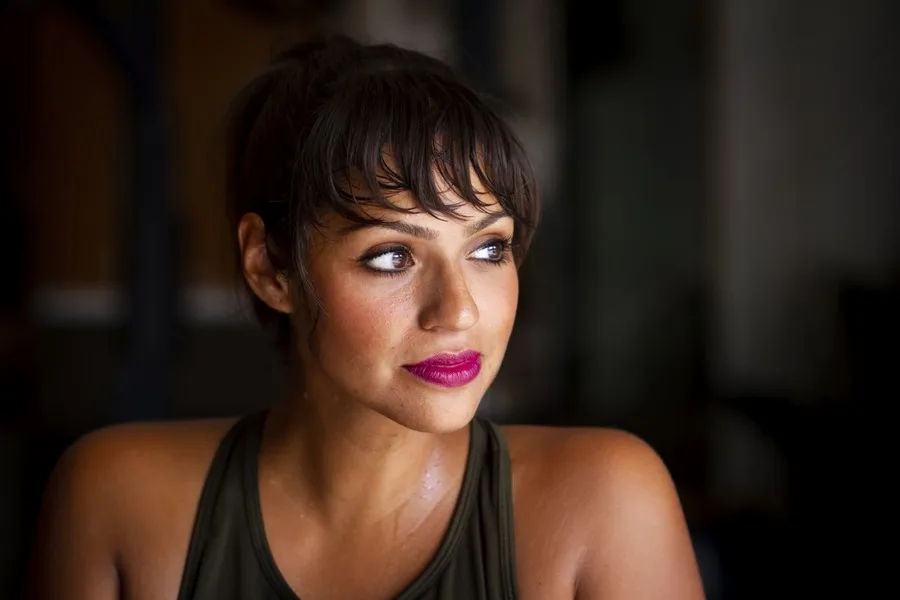 Woman in black tank-top and short hair