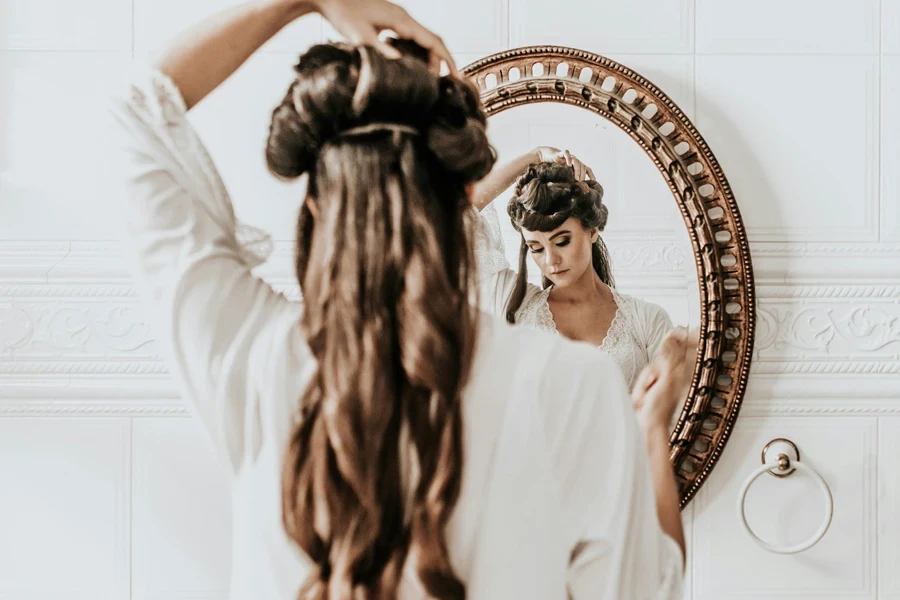 woman wearing white dress standing in front of mirror