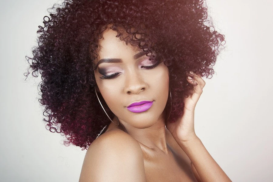 woman with curly hair posing for a photo