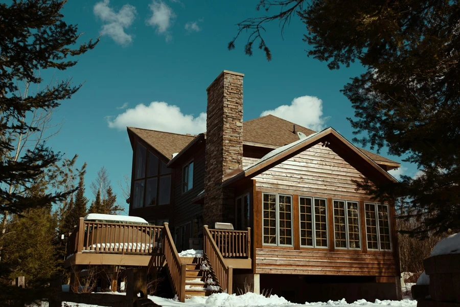 wooden house with wood deck railing