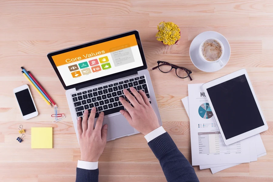 A business man checking core values on a laptop