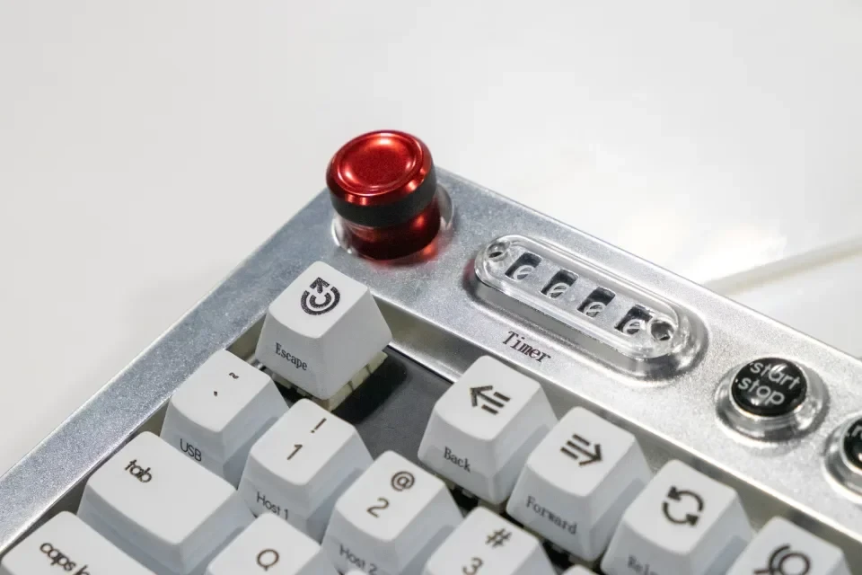 A large red circular button on a keyboard for media control.