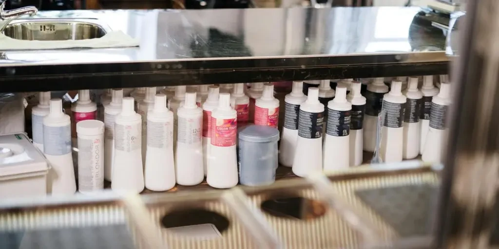 A neat arrangement of hair care products on a salon shelf. Ideal for hairstyling concepts