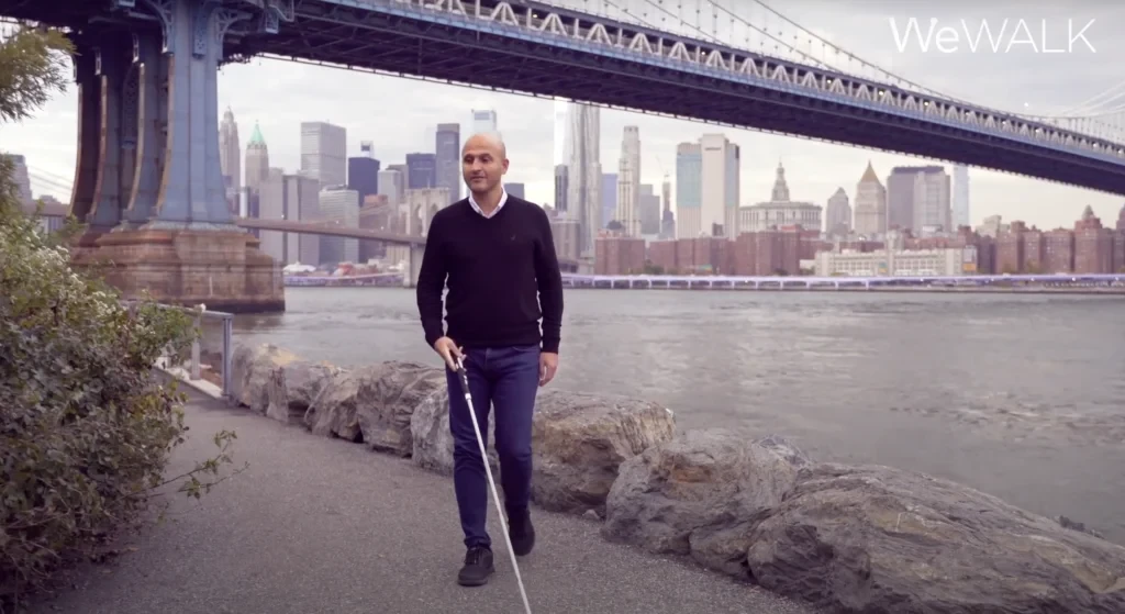 A person demonstrating the use of a smart cane.