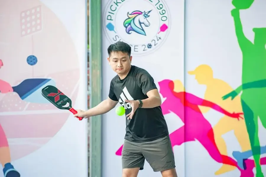 A pickleball player in action during a sporting event in Hanoi, Vietnam