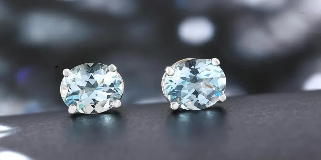 A stunning close-up of two aquamarine gemstone earrings, showcasing their intricate design and sparkling clarity