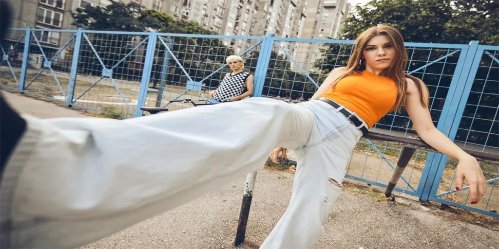 A teenage girl kicking towards camera