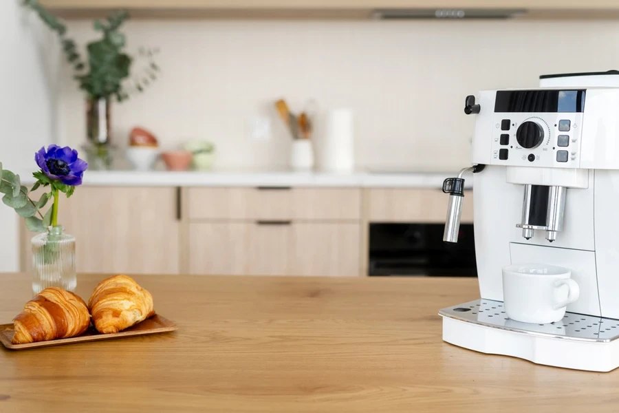 A white automatic espresso machine on a kitchen counter