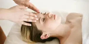 A woman enjoying a relaxing face massage at a spa for therapeutic benefits