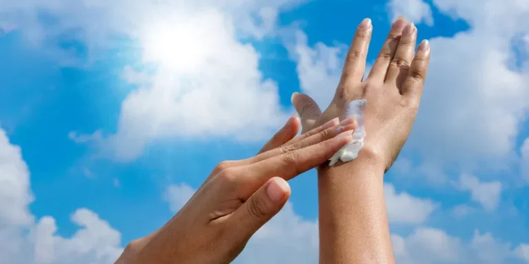 A woman is applying sunscreen and skin care to protect her skin from UV rays