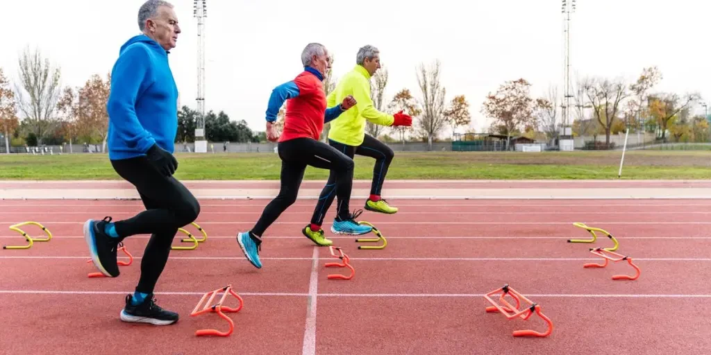 Active Senior Men Performing Agility Drills on Track