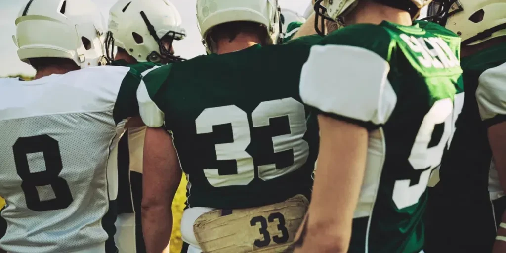 American football team huddling together before a big game