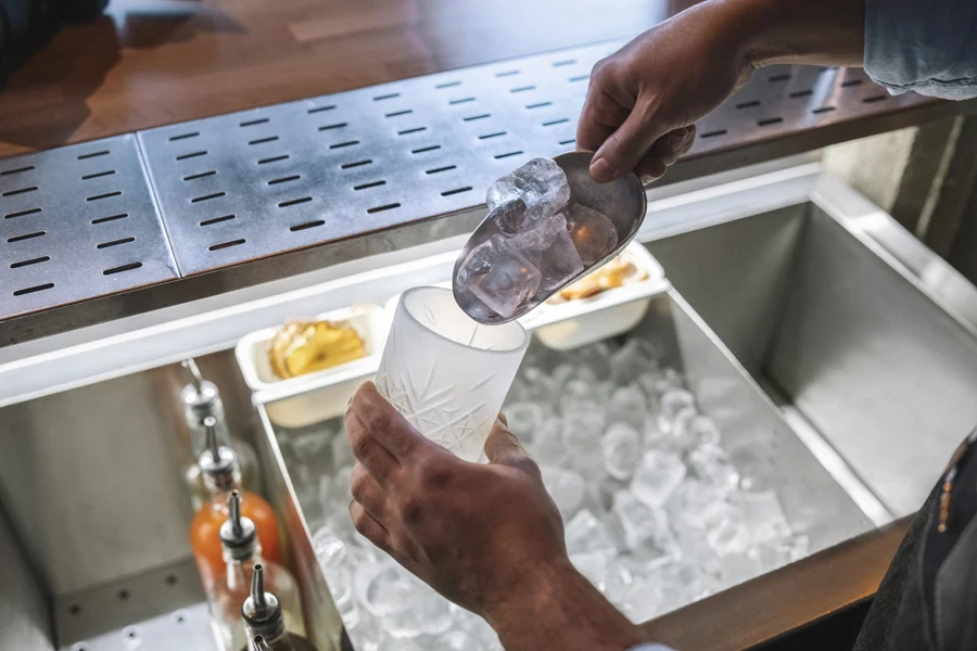 Bartender getting ice from an ice maker