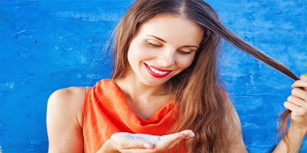 Beautiful caucasian woman in red t-shirt with white powder in her palm