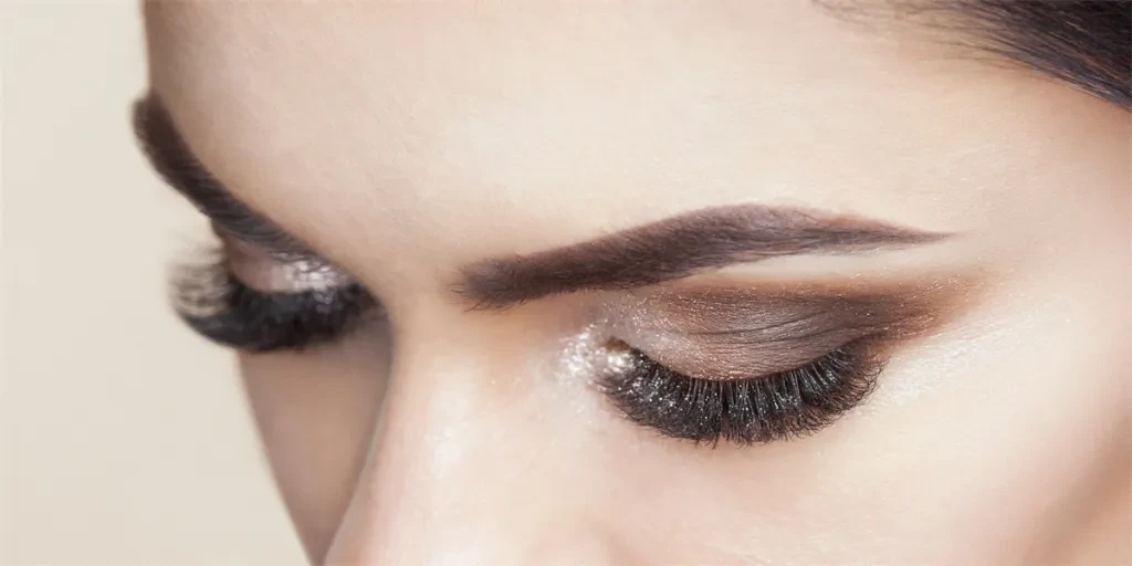 Beautiful woman with long eyelashes and with beautiful smokey eyes make-up
