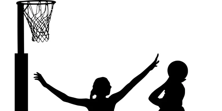 Black on white silhouette of girls ladies netball players jumping and blocking goal