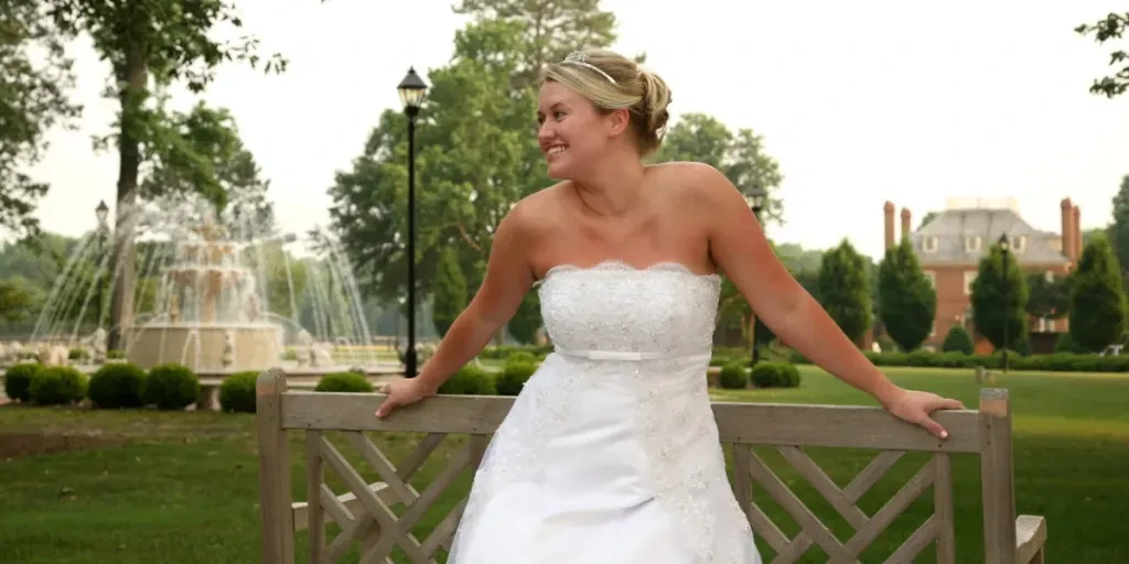 Bride leaning on a park bench