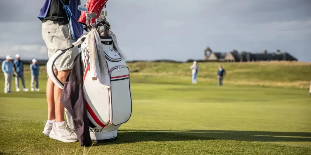 Caddy minding a golfers golf bag - with a full set of clubs