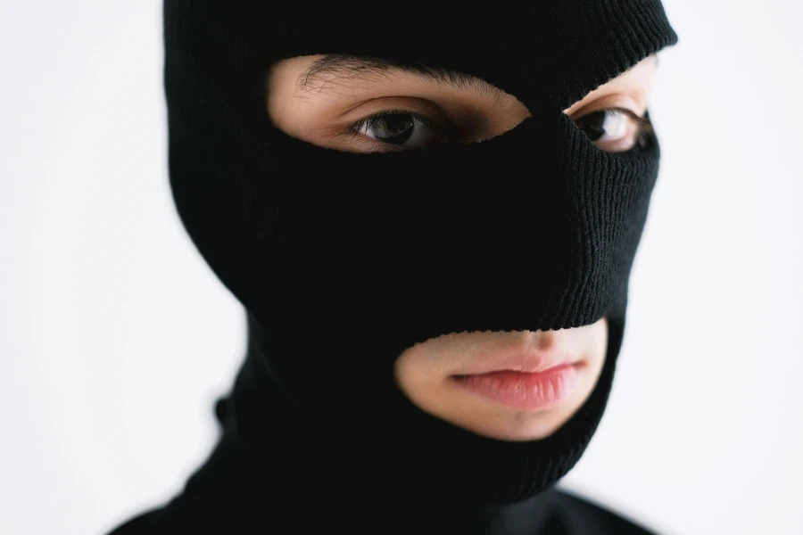 Close-up of a person wearing a black balaclava, conveying mystery or anonymity