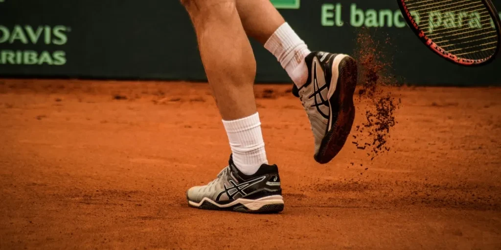 Close-up of a tennis player on a clay court in Montevideo, showcasing movement and energy
