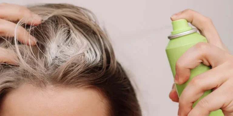 Close up of a young woman's head with dirty greasy hair