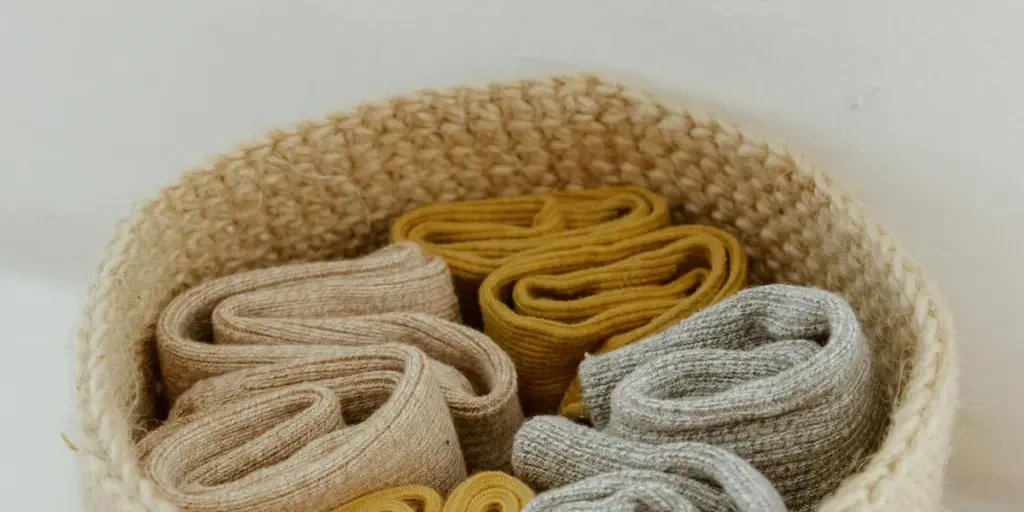 Close-up of rolled socks in a knitted basket, showcasing neat organization and texture