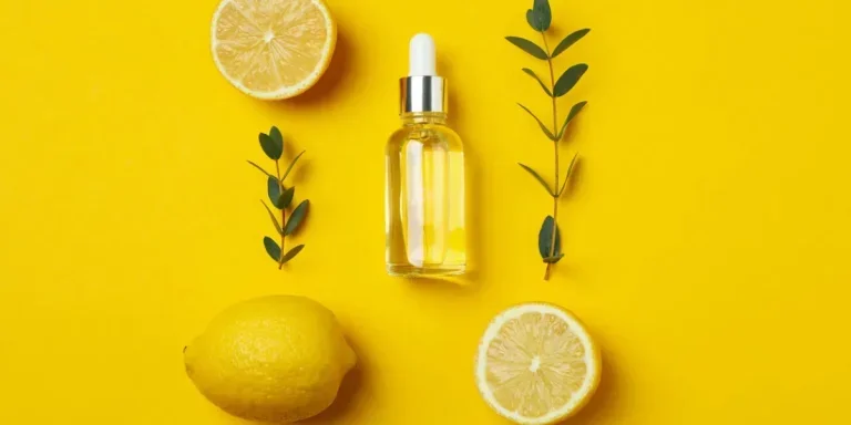 Concept of natural cosmetics with lemon oil on yellow background