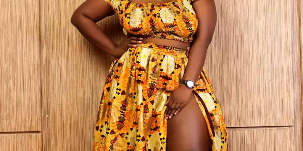 Confident African woman posing elegantly in a vibrant yellow dress, embodying style and grace