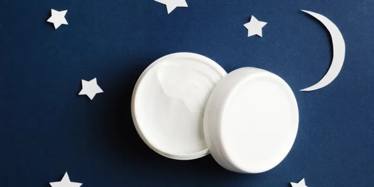 Cosmetic white container on night sky background top view