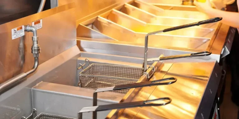 Deep fryer with boiling oil on restaurant kitchen