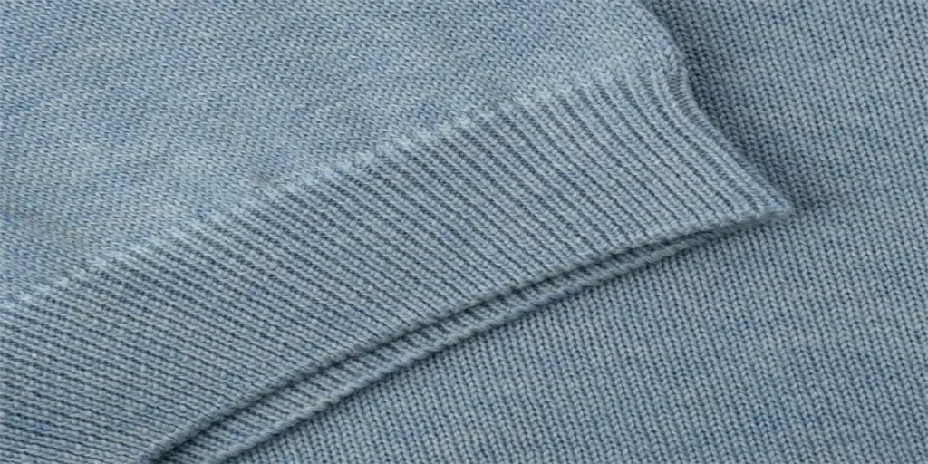 Elastic band on the sleeve of a light blue-gray knitted cotton polo t-shirt close up