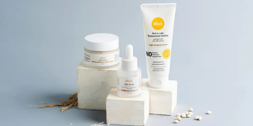 Elegant skincare and sunscreen products on a gray backdrop. Ideal for beauty marketing