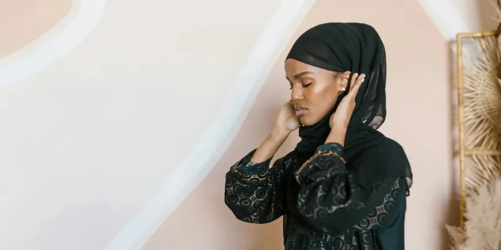 Elegant woman wearing a traditional hijab standing gracefully indoors, embodying modest fashion 