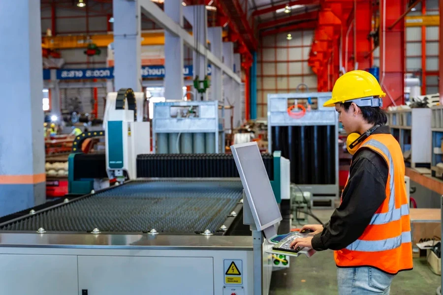 Engineering technician worker is operating machine inside factory