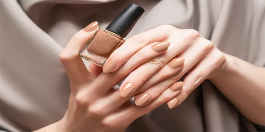 Female hand with beige nail design