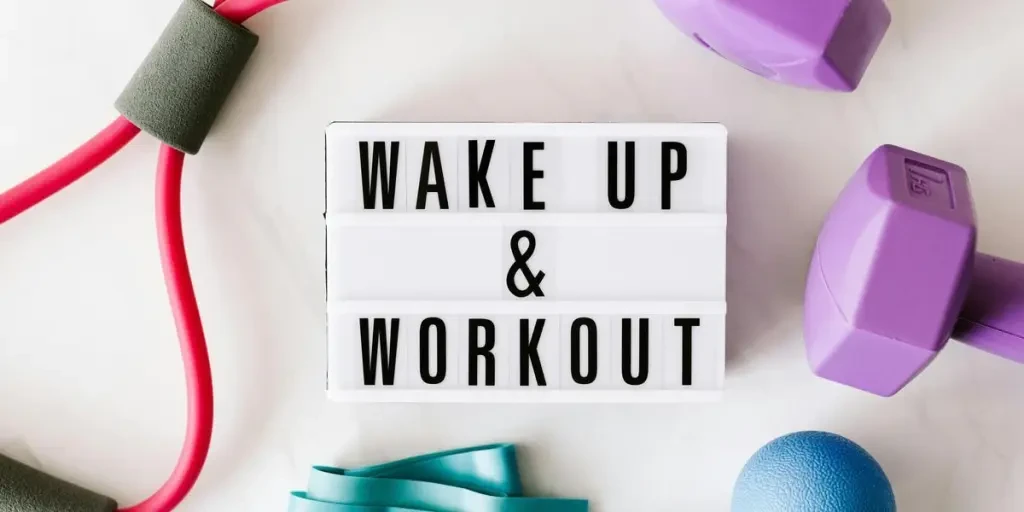 Flat lay of fitness equipment with a motivational slogan for exercise inspiration