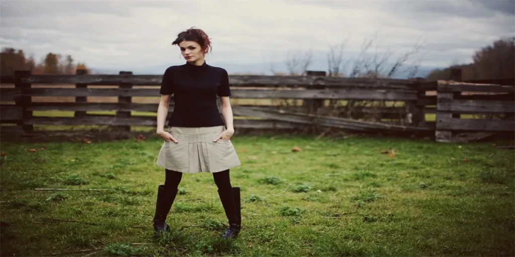 Girl with Boots Standing in Green Stable